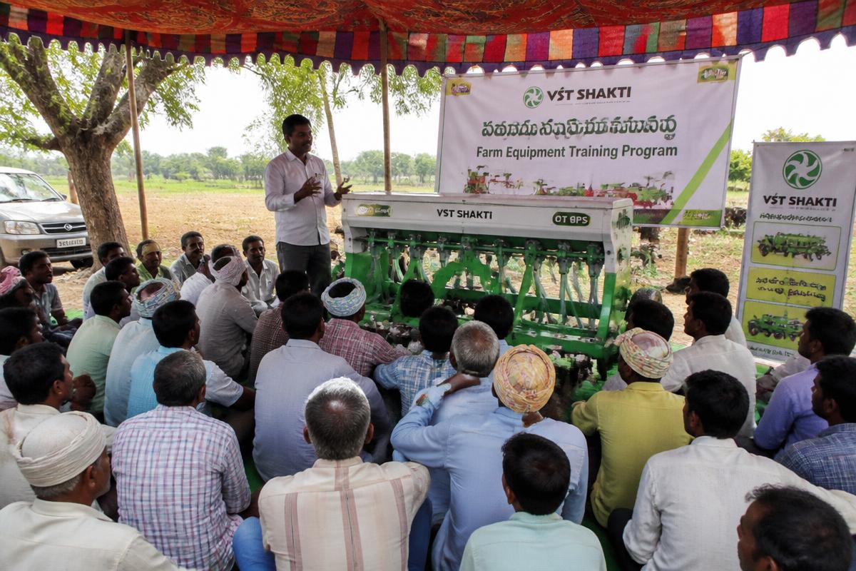 Farmers learning to operate a seed drill at a training camp in Telangana
